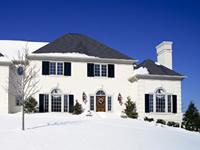 a two story house with a front lawn covered in snow